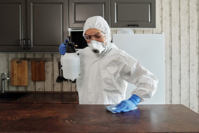 photo of person disinfecting the table